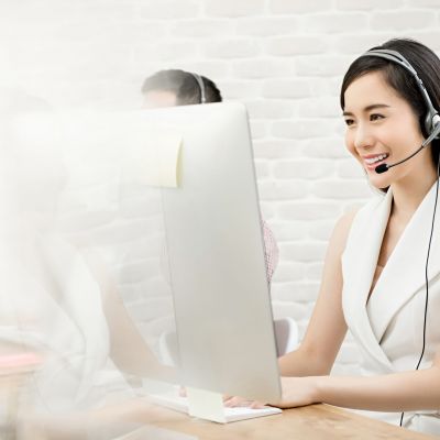 Beautiful Asian woman telemarketing customer service agent worki