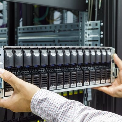 46945854 - it engineer installs equipment in the rack in datacenter